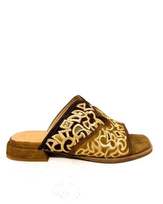 Brown sandal with decorative gold pattern on a white background