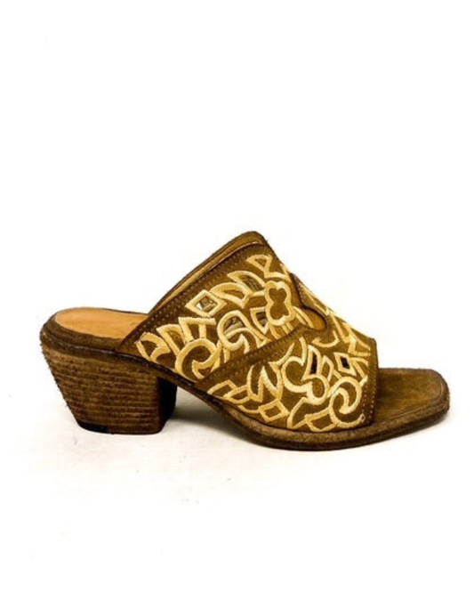 Brown sandal with intricate gold design on a white background