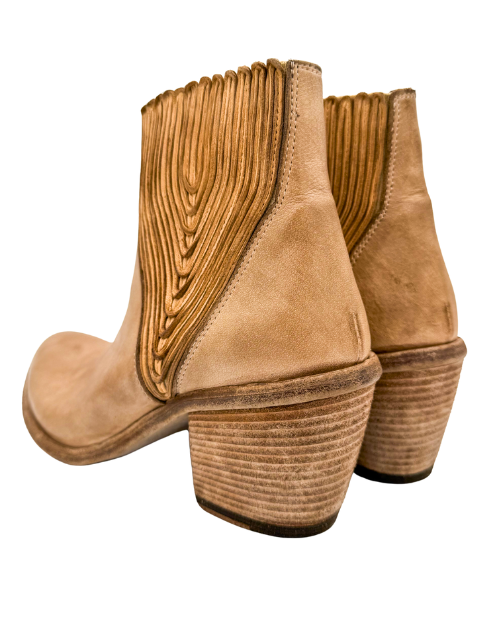 Tan ankle boots with textured design on a white background